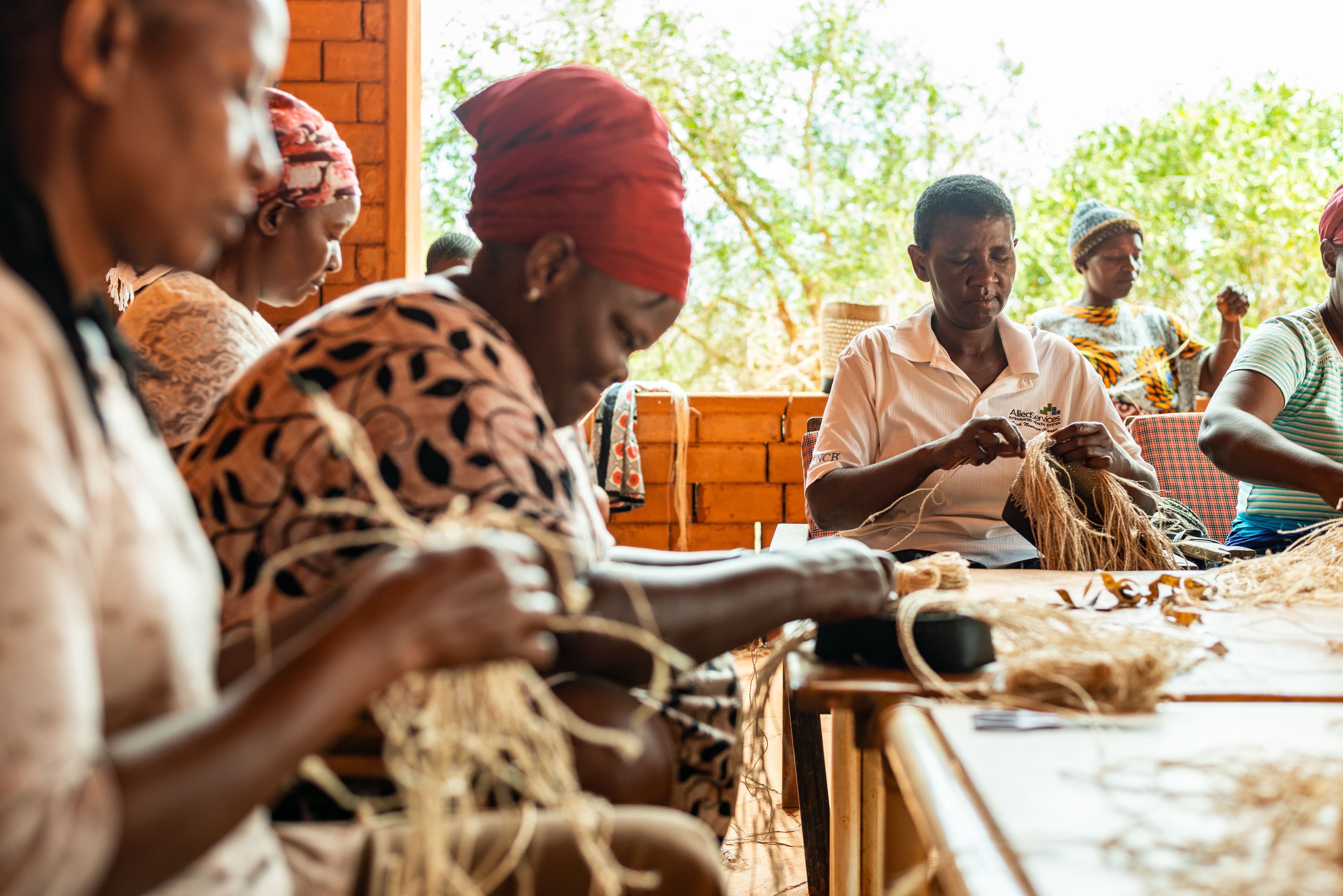 Women artisans weaving banana fiber baskets together in Kasigau, Taita Taveta County, Kenya.